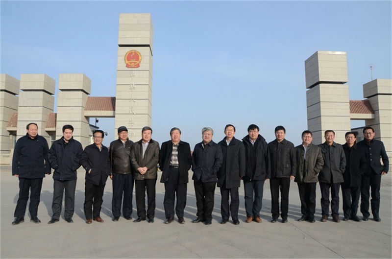 博源集團(tuán)董事局主席戴連榮（左7）、黨委副書記李培成（左6）、副總裁梁潤彪（右7）一行在策克口岸國門前合影
